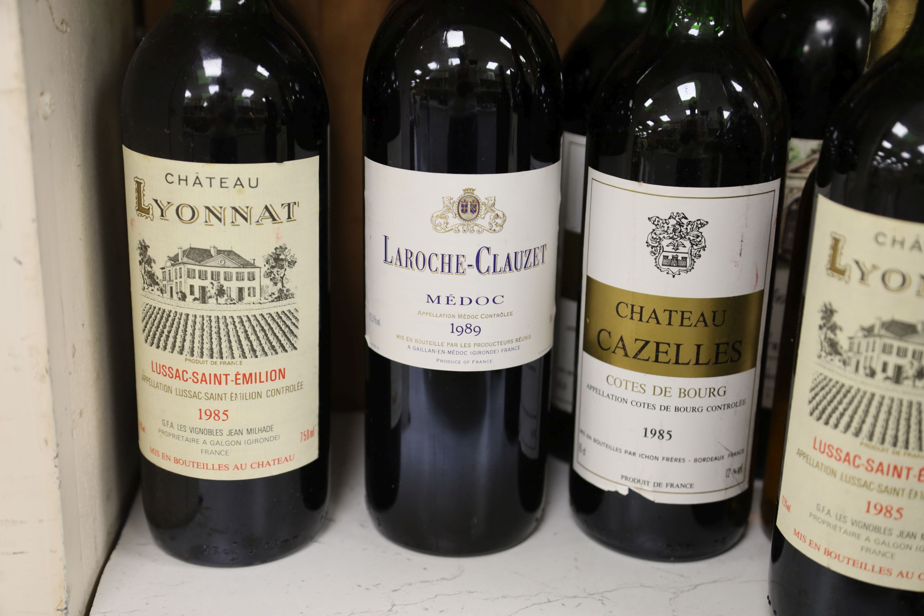 Ten assorted red Bordeaux wines and a white half bottle.